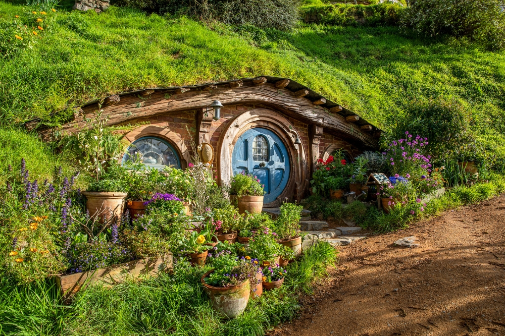 A Hobbit house covered in grass on the Hobbiton™ Movie Set