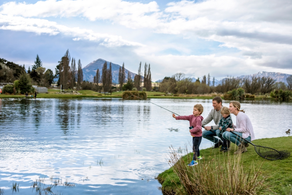A family are fishing on Lake Wanaka